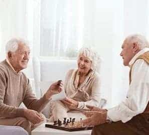 a group of elderly people playing a game of chess.