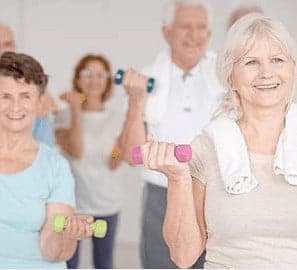 a group of older people doing exercises with dumbbells.