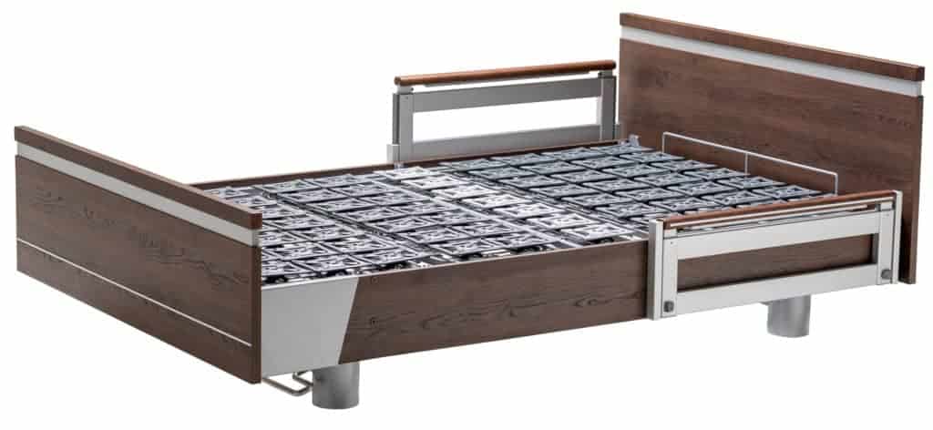 a bed with a wooden headboard and a metal frame.