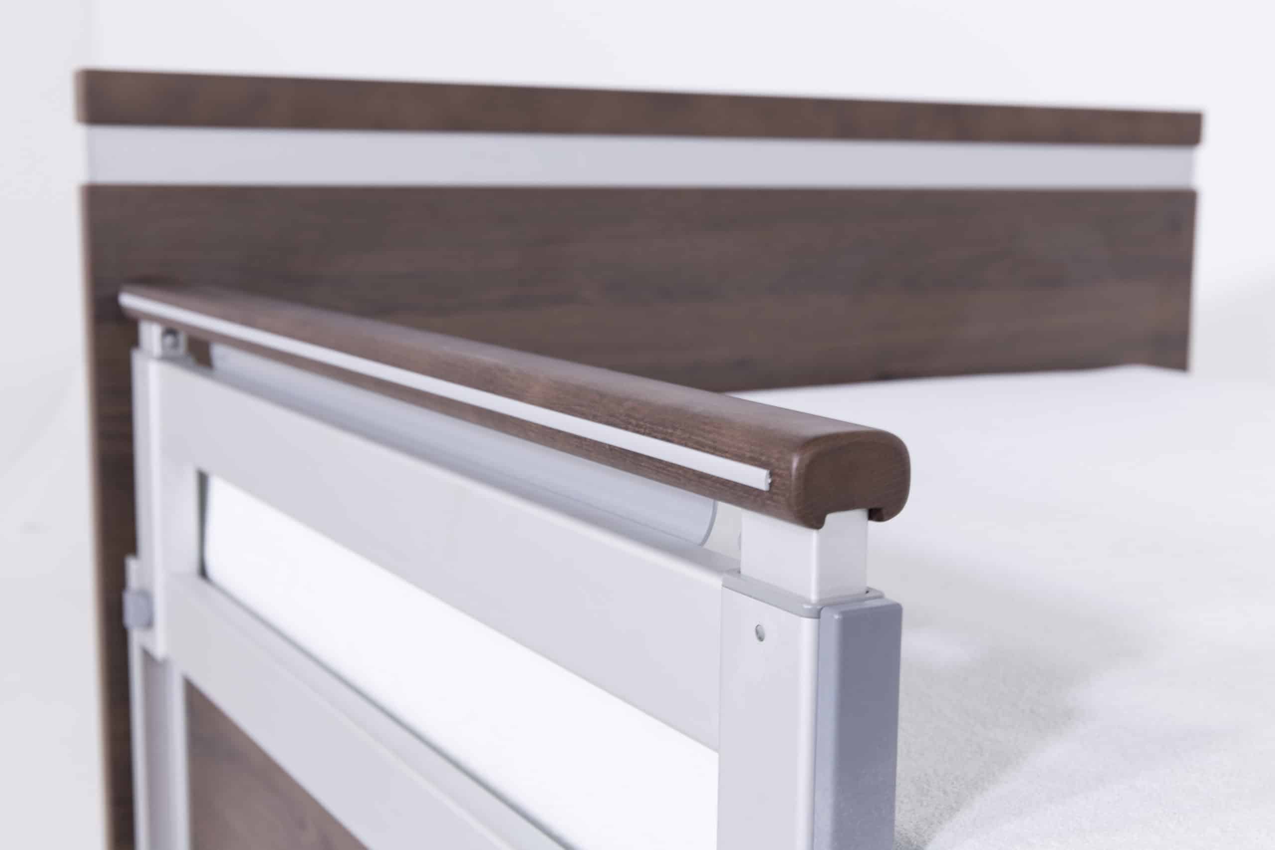 a close up of a bed with a wooden headboard.