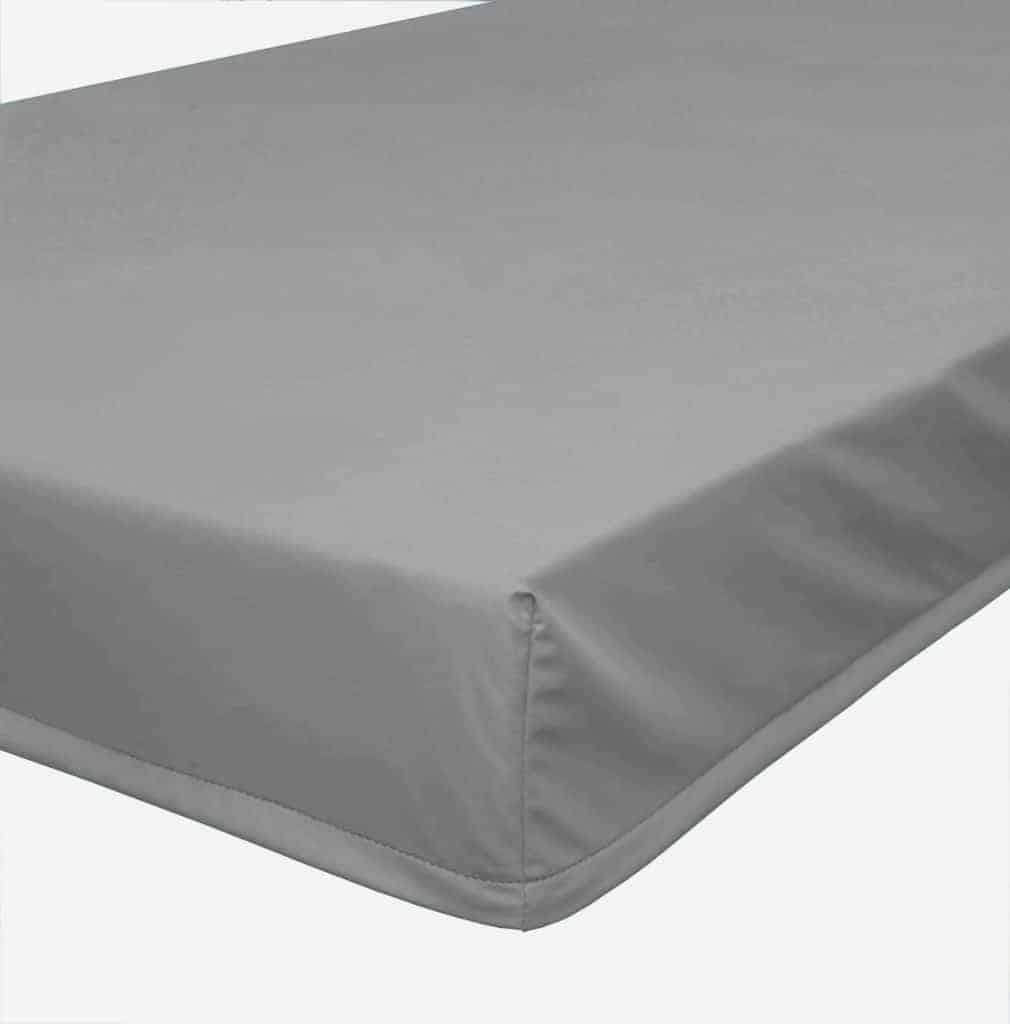 a close up of a bed with a sheet on it.