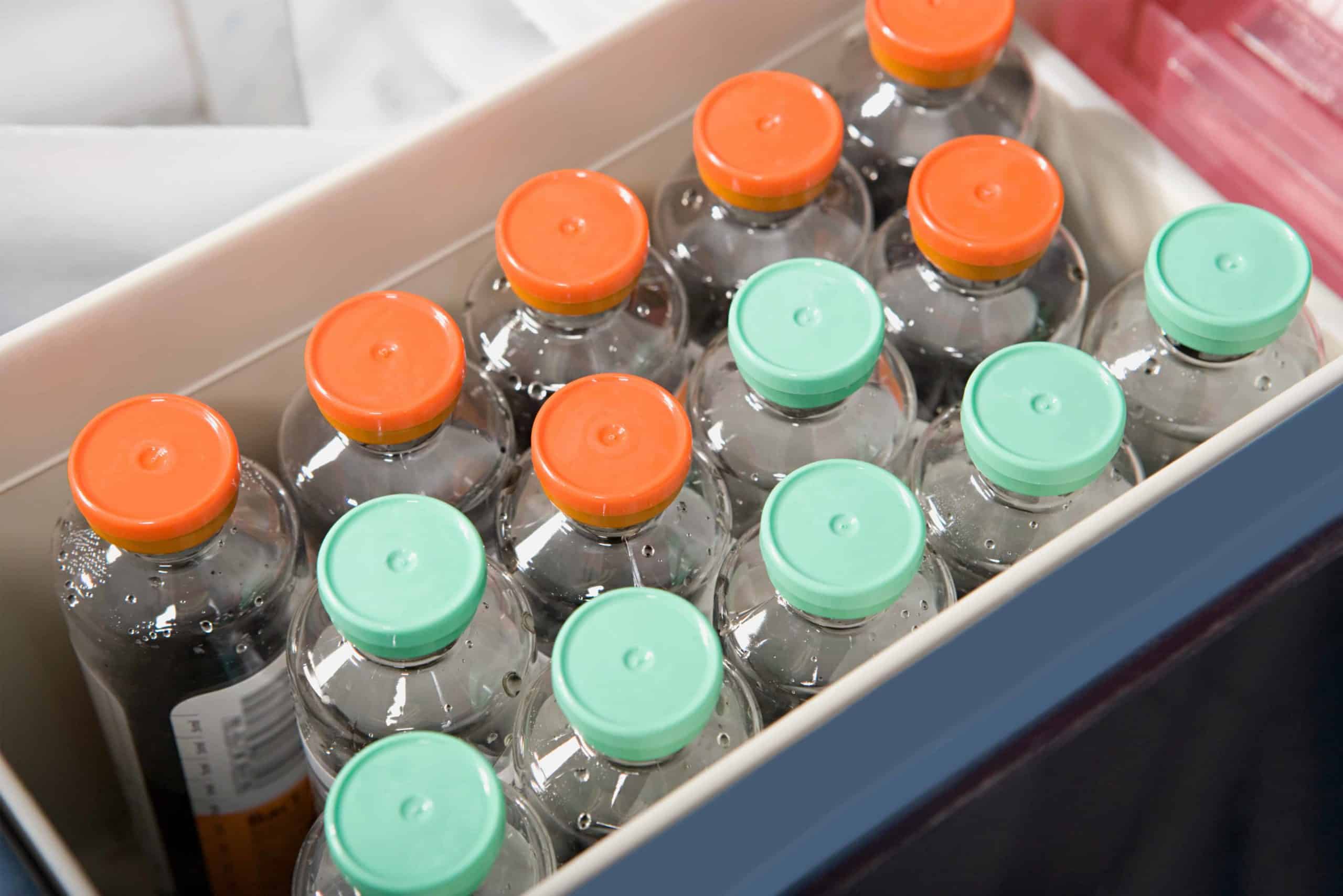 a box filled with lots of bottles of water.