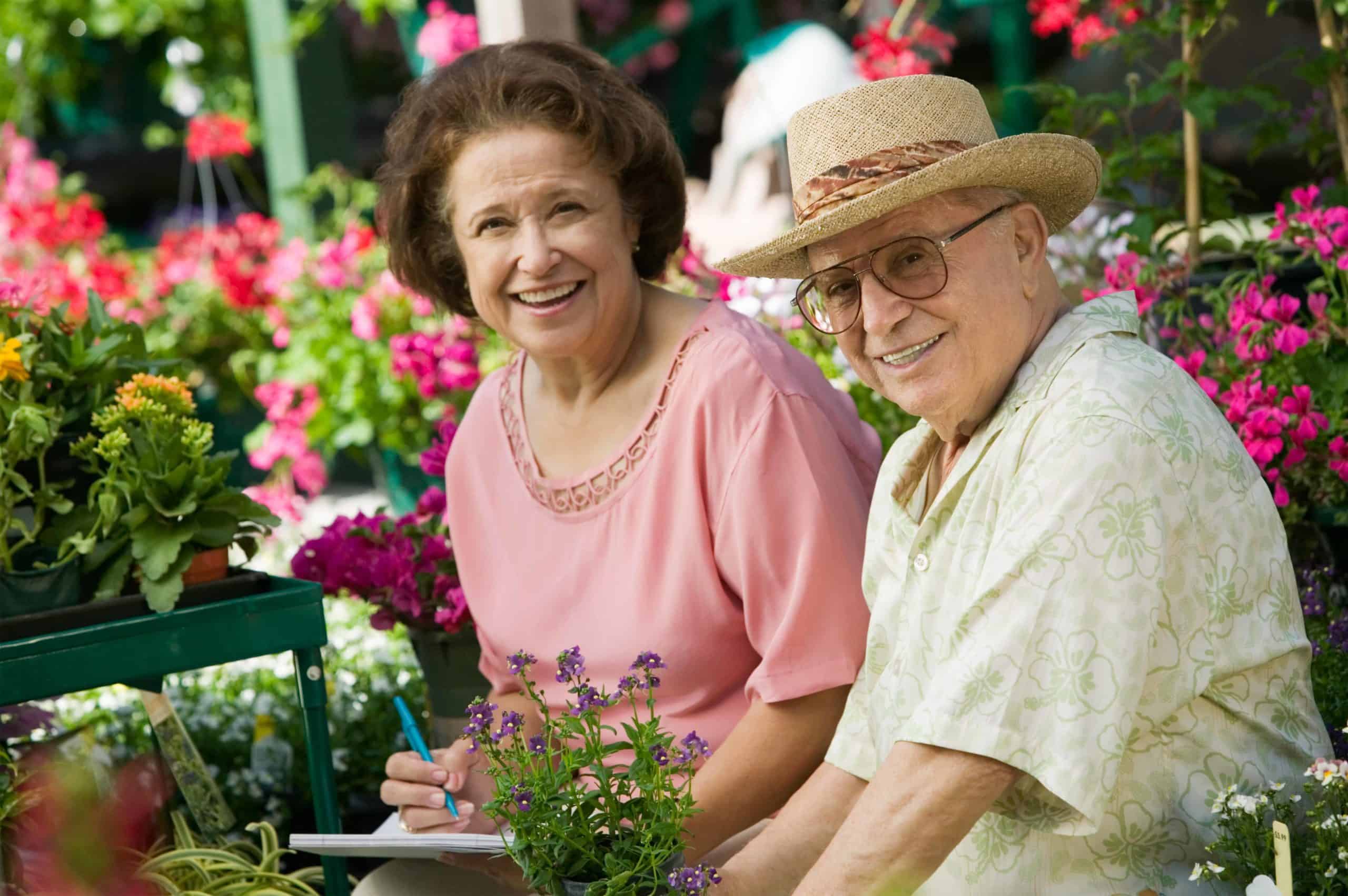 a man and a woman sitting next to each other in a garden.