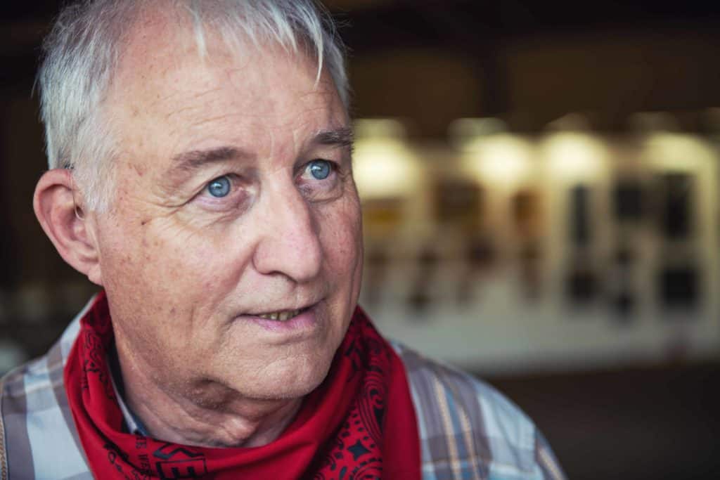 a close up of a person wearing a red scarf.