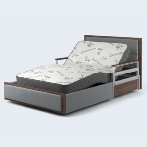 The SonderCare Aura™ Platinum Wide Hospital Bed is a large, luxurious hospital bed featuring an adjustable mattress, an elegant wooden headboard, side rails for safety, and a patterned cover for added comfort.
