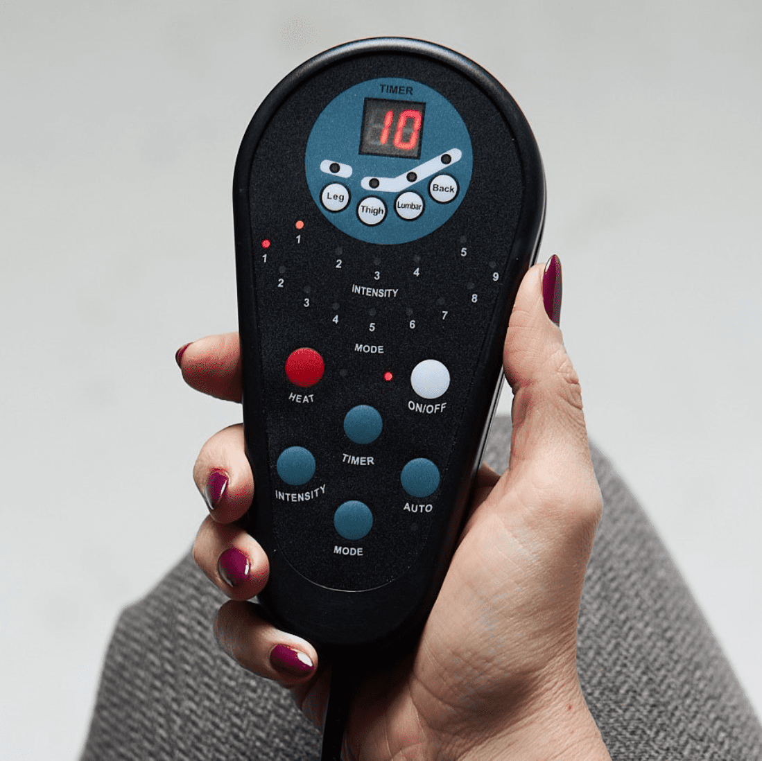 a woman holding a remote control in her hand.