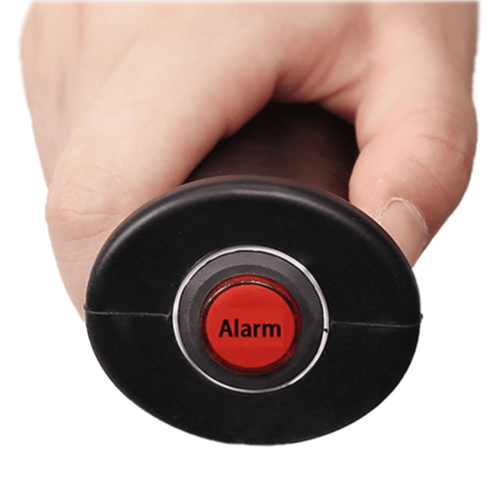 a hand holding a red button with the word alarm on it.