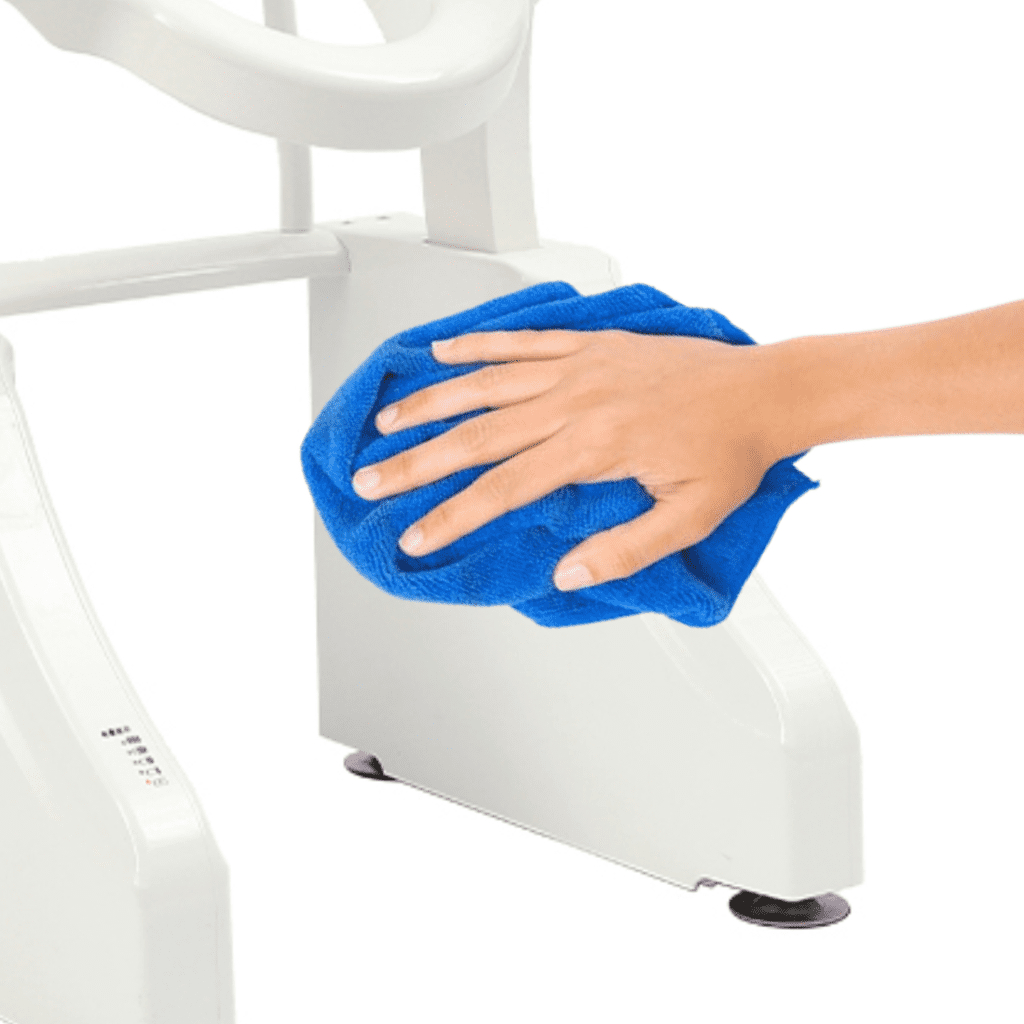 a hand with a blue rag on a white machine.