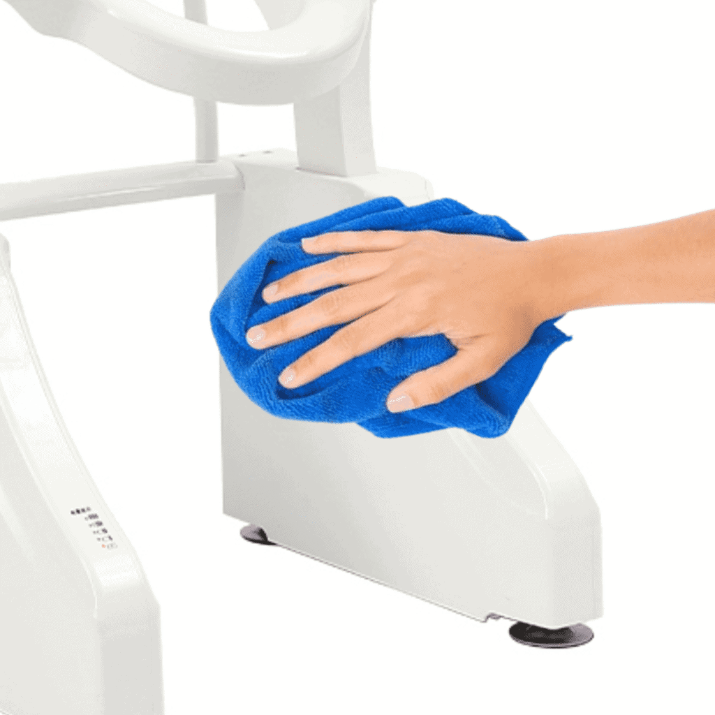 A person cleaning a toilet seat with a blue cloth.