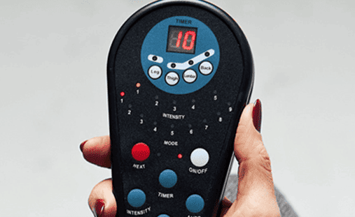 A person holding up a remote control.