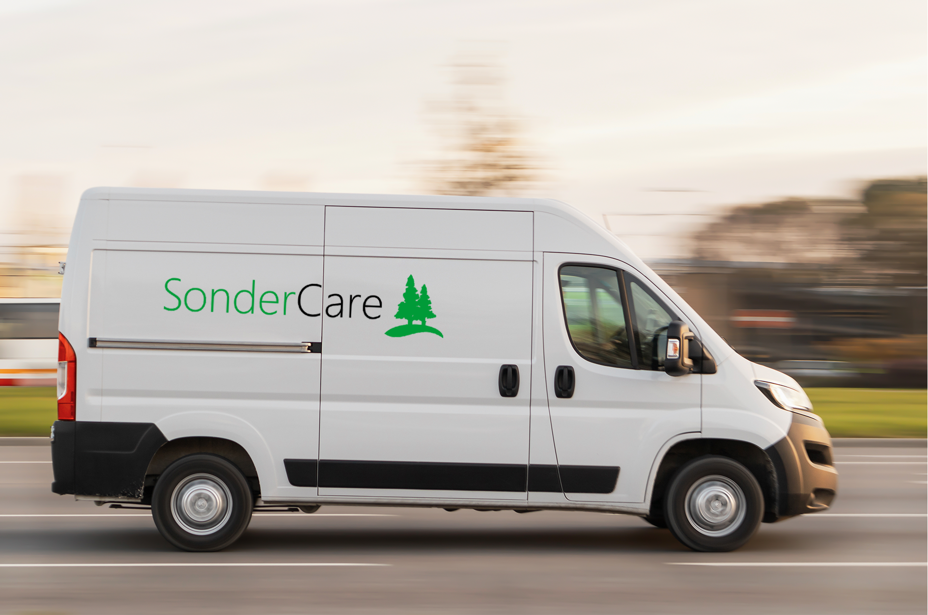 White commercial van with "sondercare - AuraPREM39" branding in motion on a roadway.