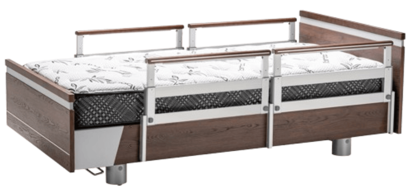 Hospital bed featuring PR39 side rails, a sturdy wood and metal frame, and a mattress with a patterned cover.