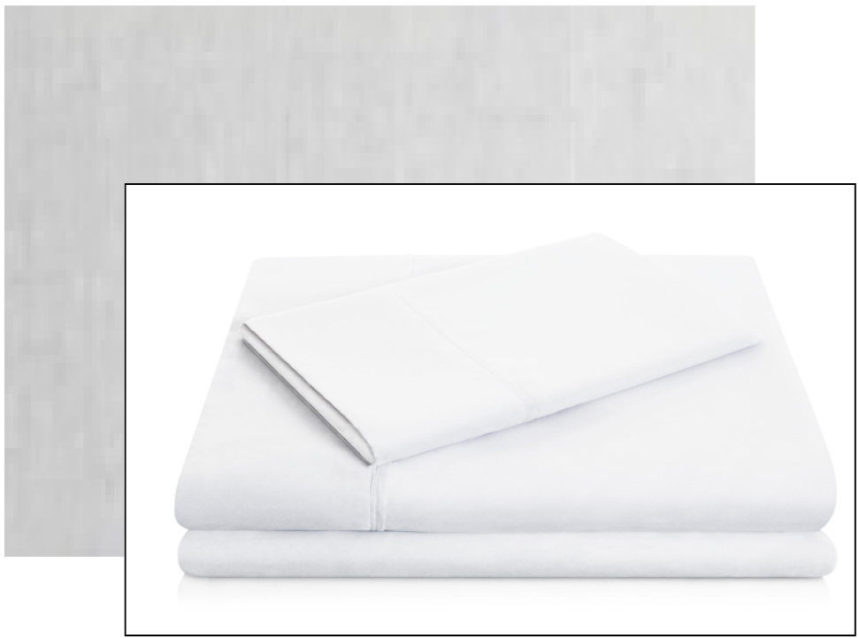 A stack of neatly folded white sheets on a reflective white surface.