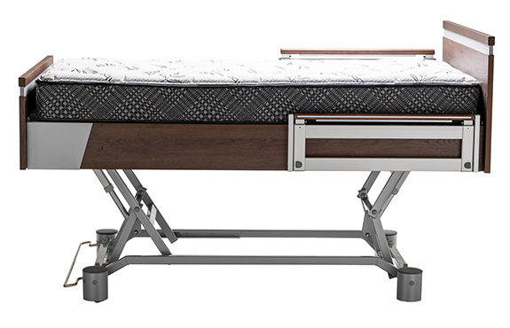 Adjustable hospital bed with a metal frame, dark wood accents, and a patterned mattress, shown in a side profile view.