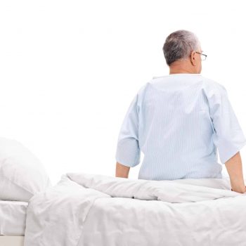 A man sitting on a wall with an electric adjustable bed.