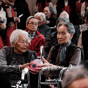 a group of elderly people sitting next to each other.