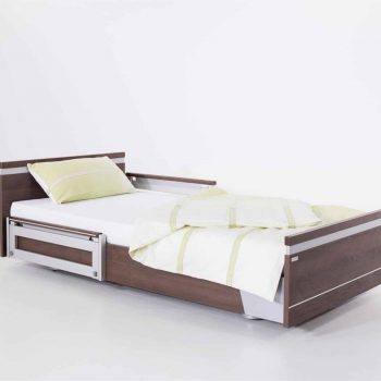 a bed with a wooden frame and white sheets.